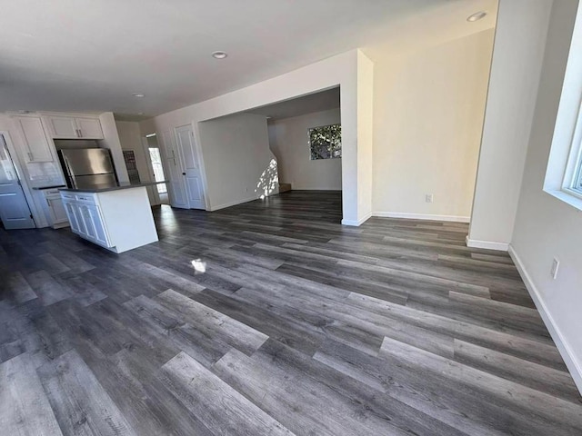 unfurnished living room featuring dark hardwood / wood-style floors