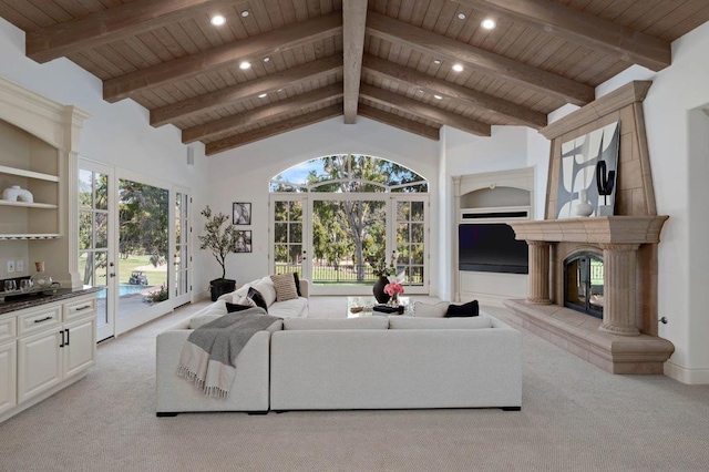 carpeted living room featuring a tile fireplace, french doors, and wood ceiling