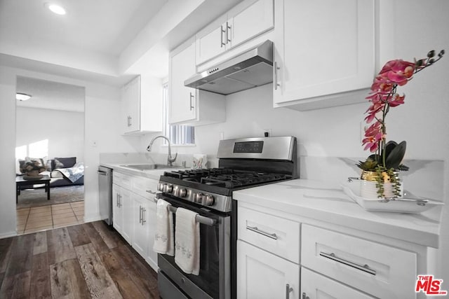 kitchen featuring sink, dark wood-type flooring, white cabinets, and appliances with stainless steel finishes