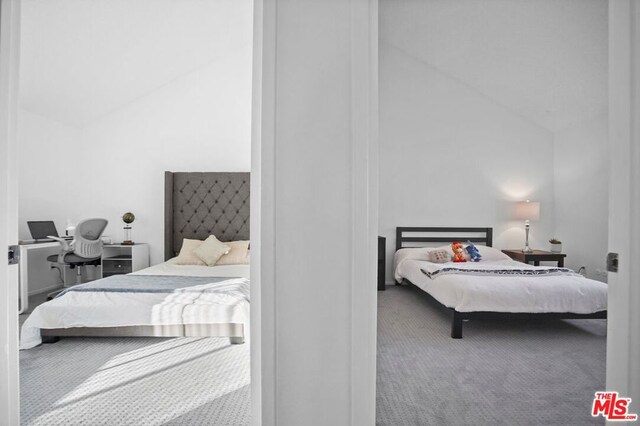 bedroom with high vaulted ceiling and carpet