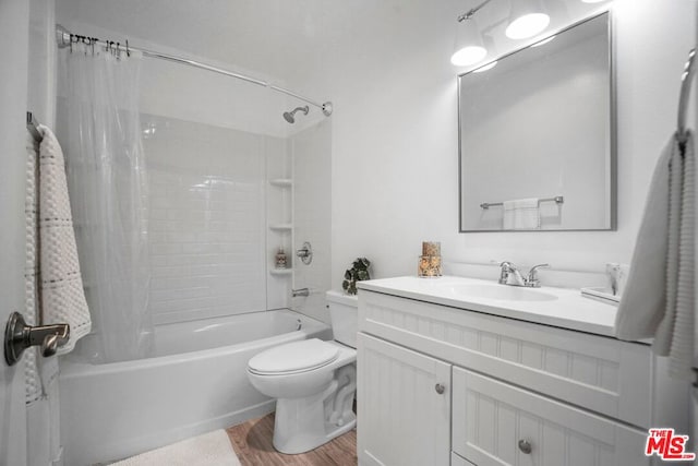 full bathroom featuring vanity, toilet, hardwood / wood-style floors, and shower / bath combo