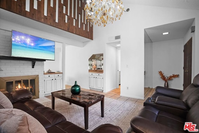 tiled living room featuring a fireplace and a high ceiling