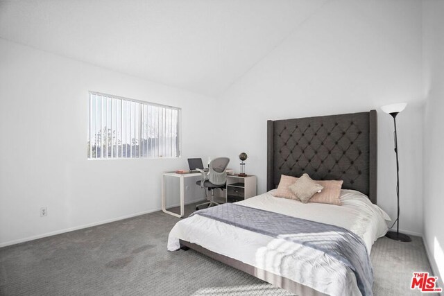 bedroom with lofted ceiling and carpet flooring