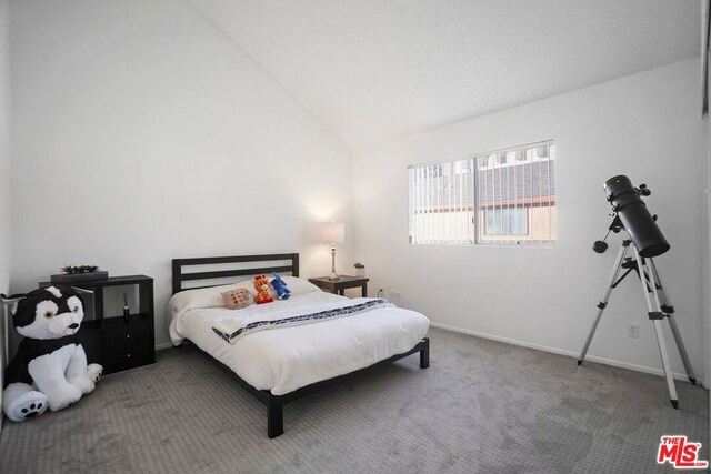 carpeted bedroom featuring lofted ceiling