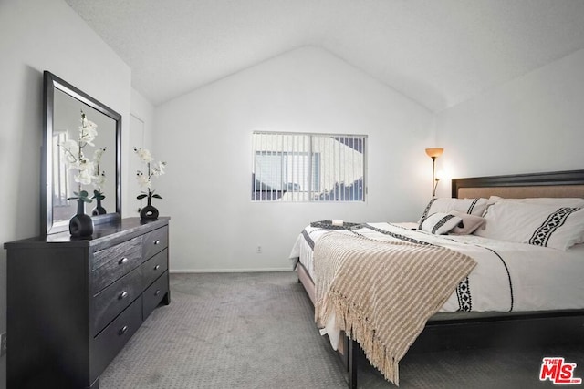 carpeted bedroom with vaulted ceiling