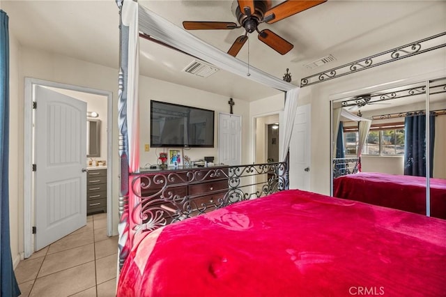 tiled bedroom with ceiling fan and connected bathroom