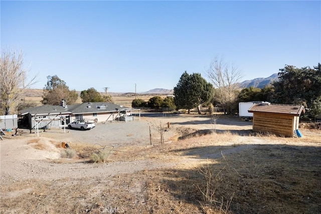 view of yard featuring a mountain view and a rural view