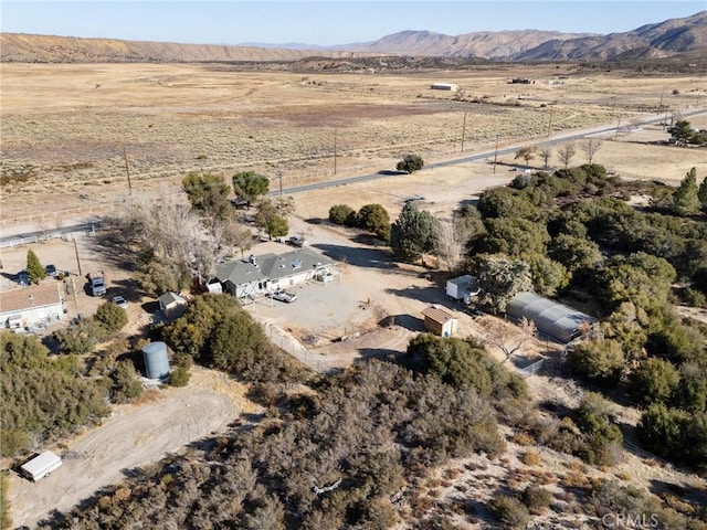 birds eye view of property featuring a mountain view and a rural view