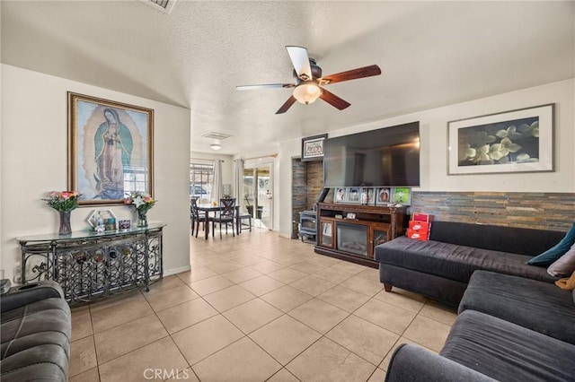 tiled living room featuring ceiling fan and a textured ceiling