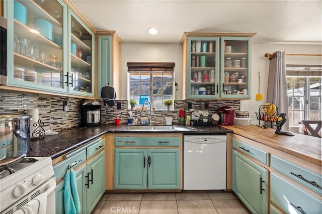 kitchen with plenty of natural light, white appliances, sink, and tasteful backsplash