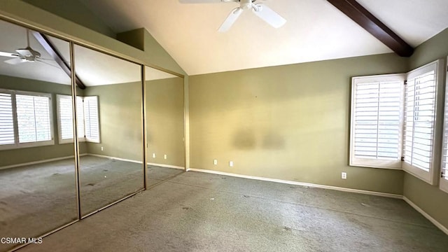 unfurnished bedroom featuring carpet flooring, vaulted ceiling with beams, ceiling fan, and a closet