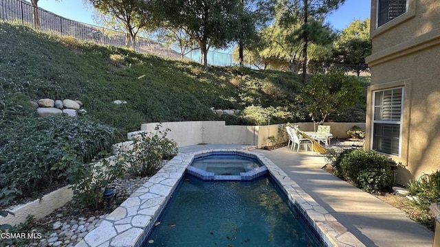 view of pool with an in ground hot tub and a patio