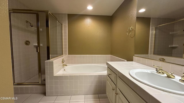 bathroom with vanity, tile patterned flooring, and plus walk in shower