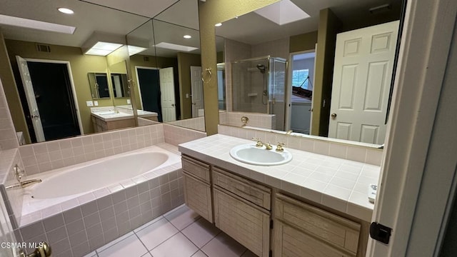 bathroom with tile patterned floors, vanity, and separate shower and tub