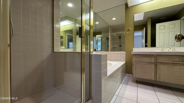 bathroom featuring vanity, tile patterned flooring, and plus walk in shower