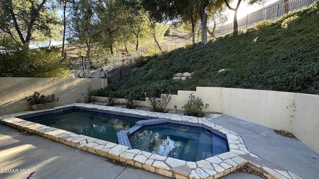 view of pool with an in ground hot tub