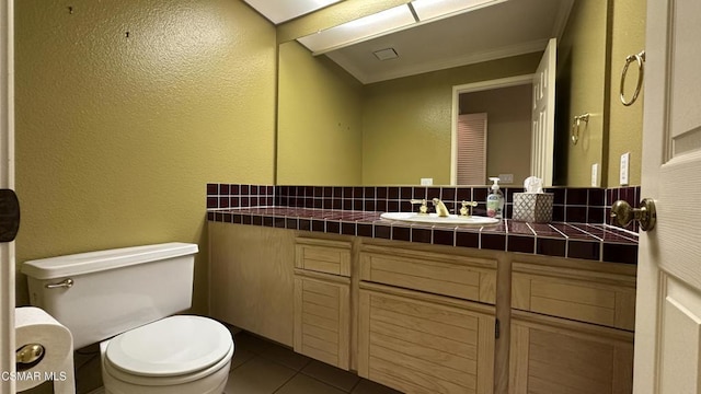 bathroom featuring tile patterned floors, vanity, and toilet