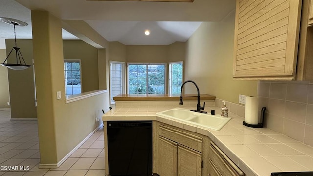 kitchen featuring tile counters, dishwasher, sink, and a wealth of natural light