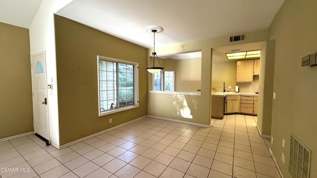 unfurnished dining area featuring light tile patterned floors