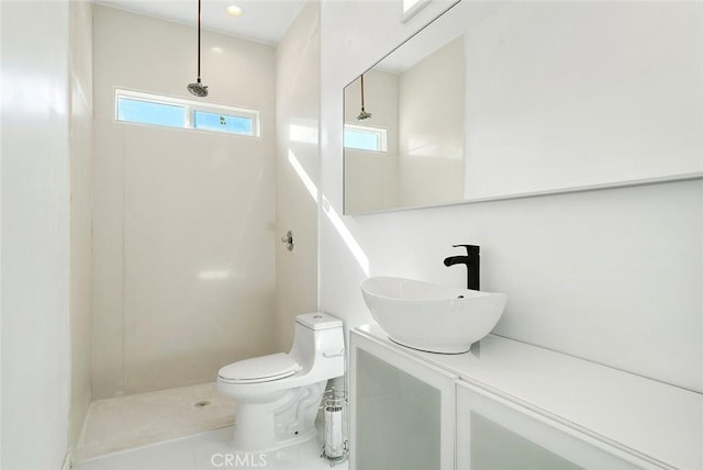 bathroom with toilet, walk in shower, vanity, and tile patterned floors