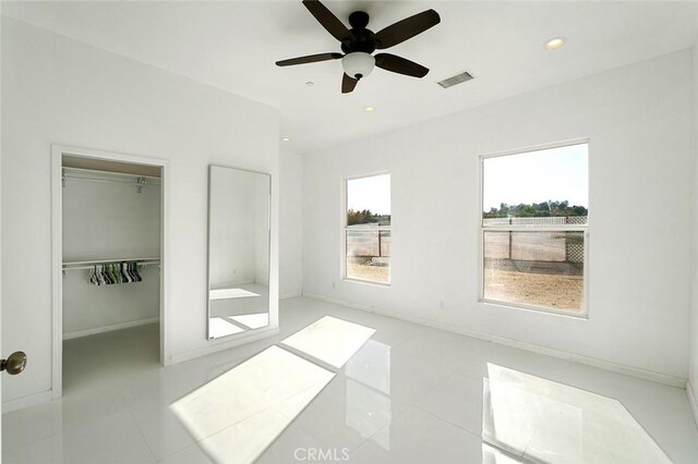 unfurnished bedroom featuring a closet, baseboards, tile patterned flooring, visible vents, and recessed lighting