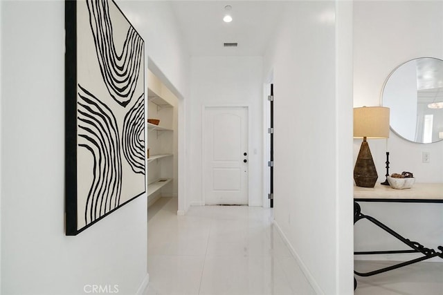 hall with recessed lighting, visible vents, baseboards, and light tile patterned flooring