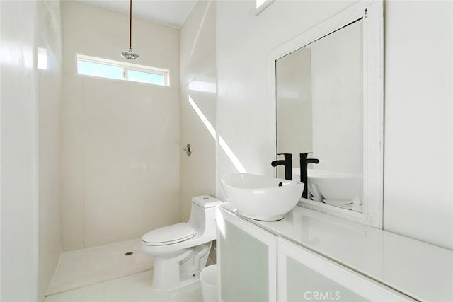 bathroom with toilet, tile patterned floors, walk in shower, and vanity