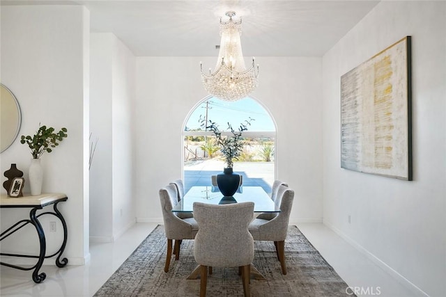 dining area featuring baseboards and an inviting chandelier