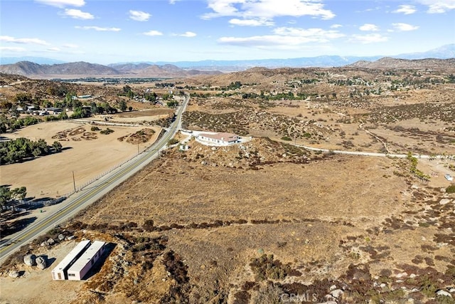 birds eye view of property featuring a mountain view and view of desert