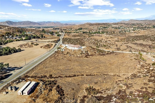 drone / aerial view featuring a mountain view, a rural view, and view of desert