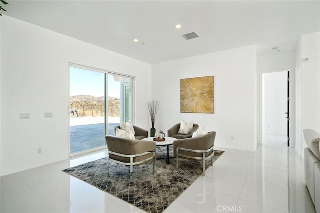 living room featuring recessed lighting, a mountain view, visible vents, and light tile patterned floors