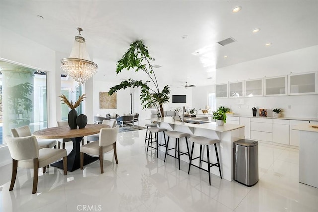 dining space with plenty of natural light, ceiling fan with notable chandelier, visible vents, and recessed lighting