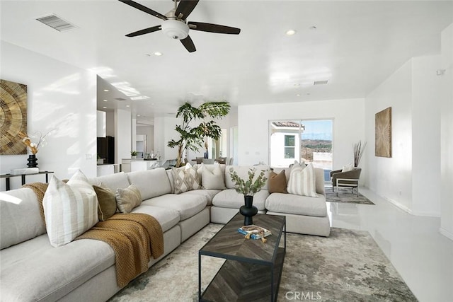 living area with recessed lighting, visible vents, a ceiling fan, and baseboards