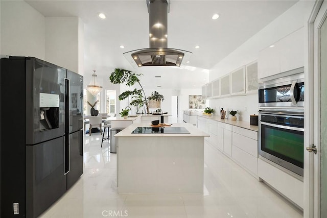 kitchen with island range hood, modern cabinets, a center island, black appliances, and white cabinetry