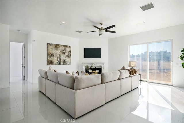 living room featuring ceiling fan, a premium fireplace, visible vents, and recessed lighting