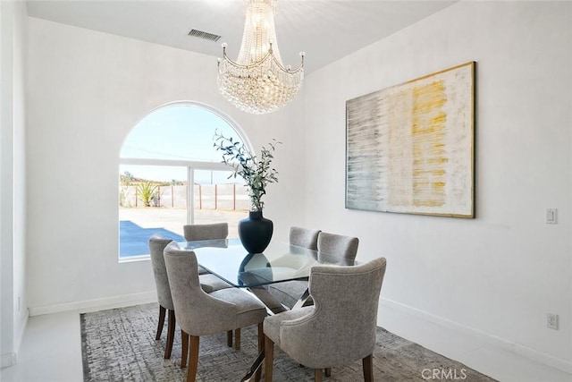 dining space featuring a chandelier, visible vents, and baseboards