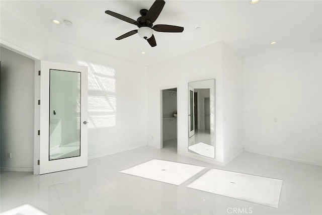 unfurnished bedroom featuring a spacious closet, a ceiling fan, recessed lighting, and tile patterned flooring