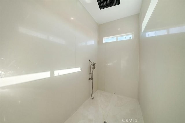 bathroom with visible vents and a tile shower