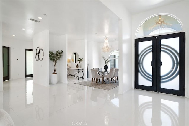 foyer featuring recessed lighting, a notable chandelier, visible vents, marble finish floor, and french doors