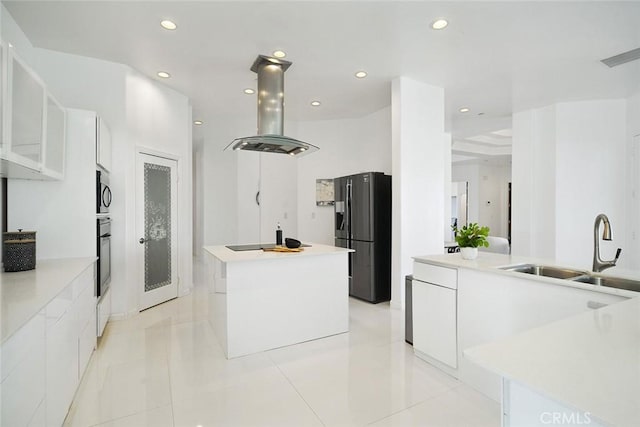 kitchen featuring a sink, black fridge with ice dispenser, island exhaust hood, modern cabinets, and a kitchen island