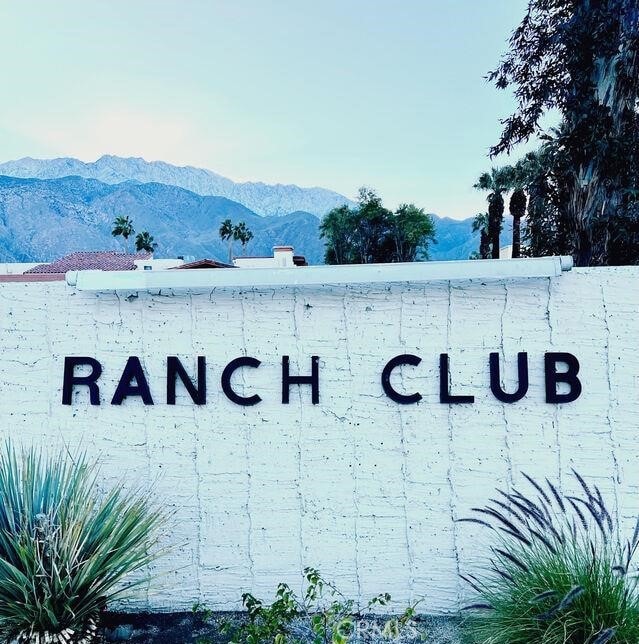 community sign with a mountain view