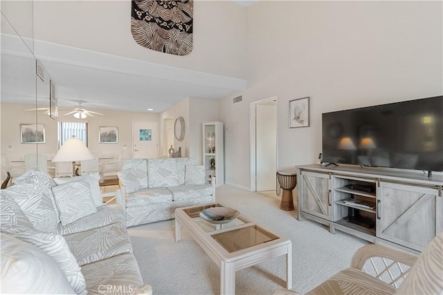 carpeted living room with ceiling fan