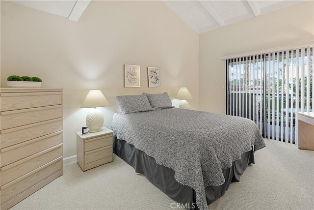 carpeted bedroom featuring lofted ceiling with beams