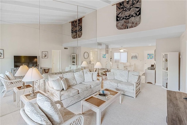 living room featuring high vaulted ceiling, ceiling fan, light carpet, and beamed ceiling