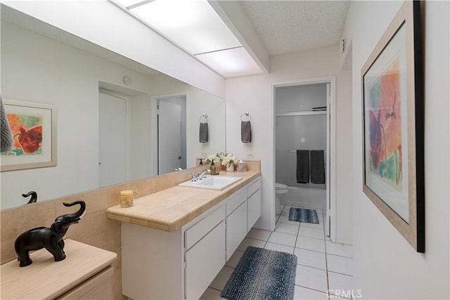 full bathroom featuring toilet, vanity, tile patterned floors, combined bath / shower with glass door, and a textured ceiling