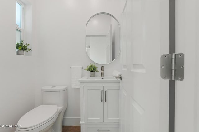 bathroom with toilet and vanity