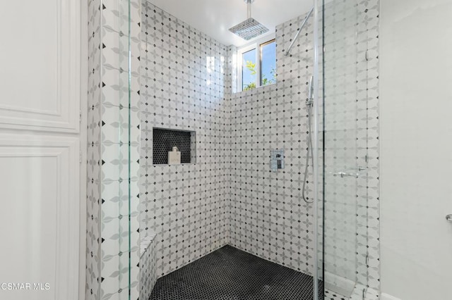 bathroom with a tile shower