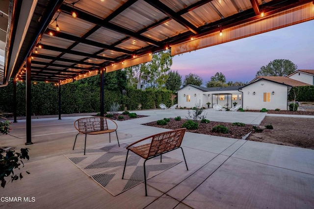 view of patio terrace at dusk