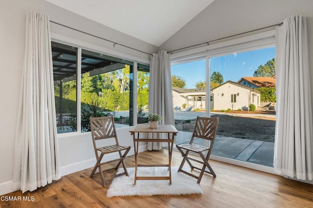 sunroom featuring vaulted ceiling