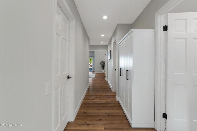 hallway with dark hardwood / wood-style floors